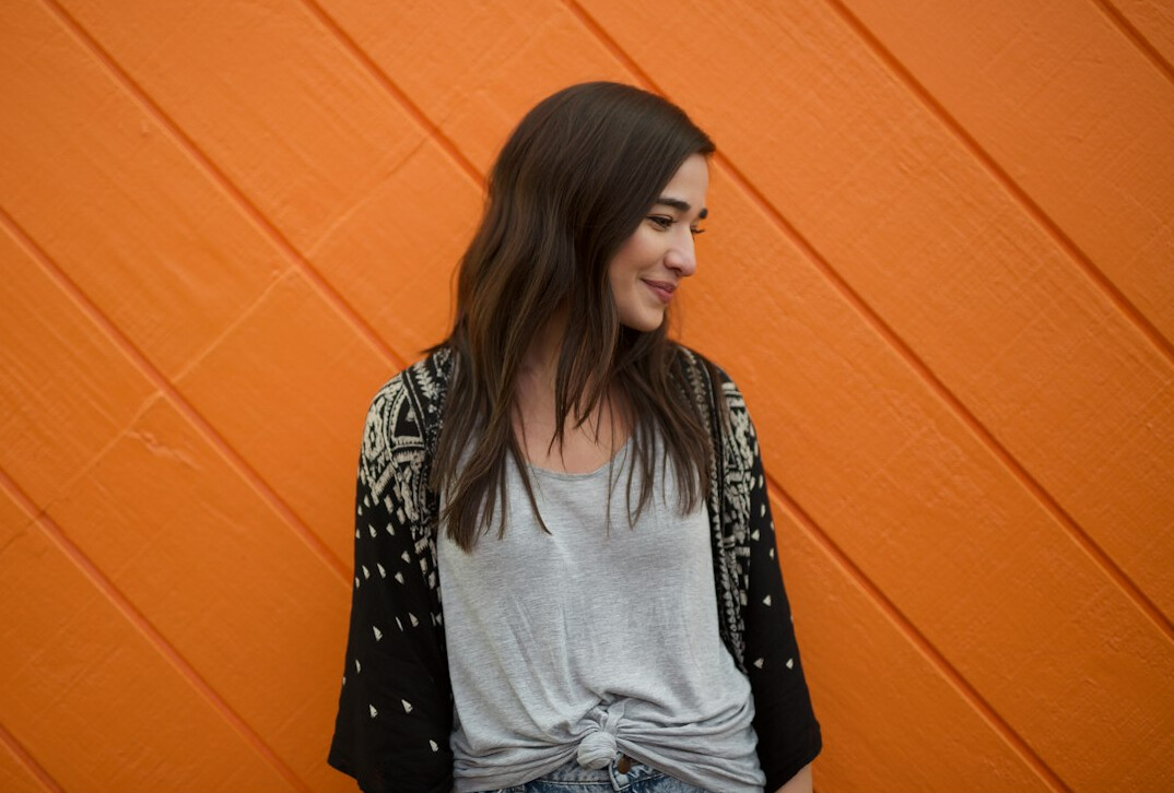Studio portrait of a Croatian woman with long brown hair smiling
